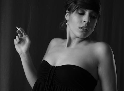 Woman in Black Strapless Top Holding Cigarette