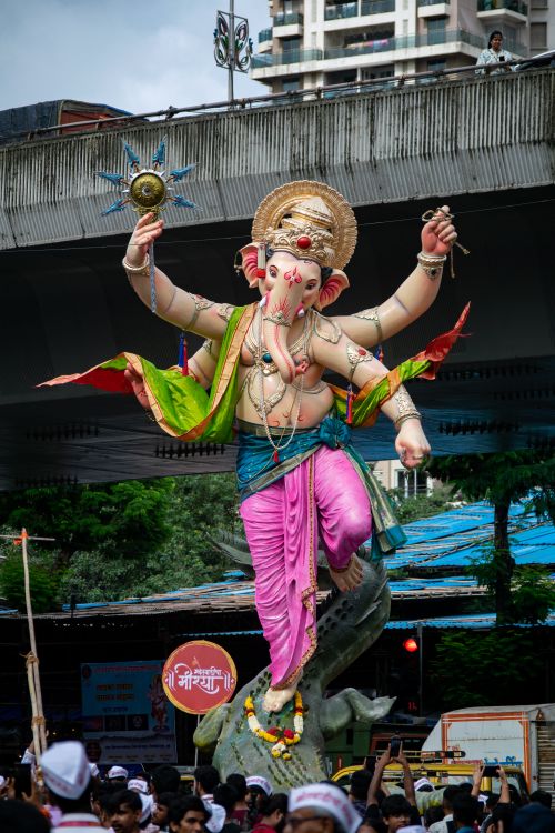 Free Colorful Ganesh statue during Mumbai's lively Ganesh Chaturthi festival parade. Stock Photo