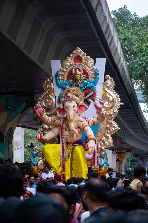 Free Vibrant celebration of Ganesh Chaturthi with a large Ganesha idol in Mumbai, capturing the lively atmosphere. Stock Photo