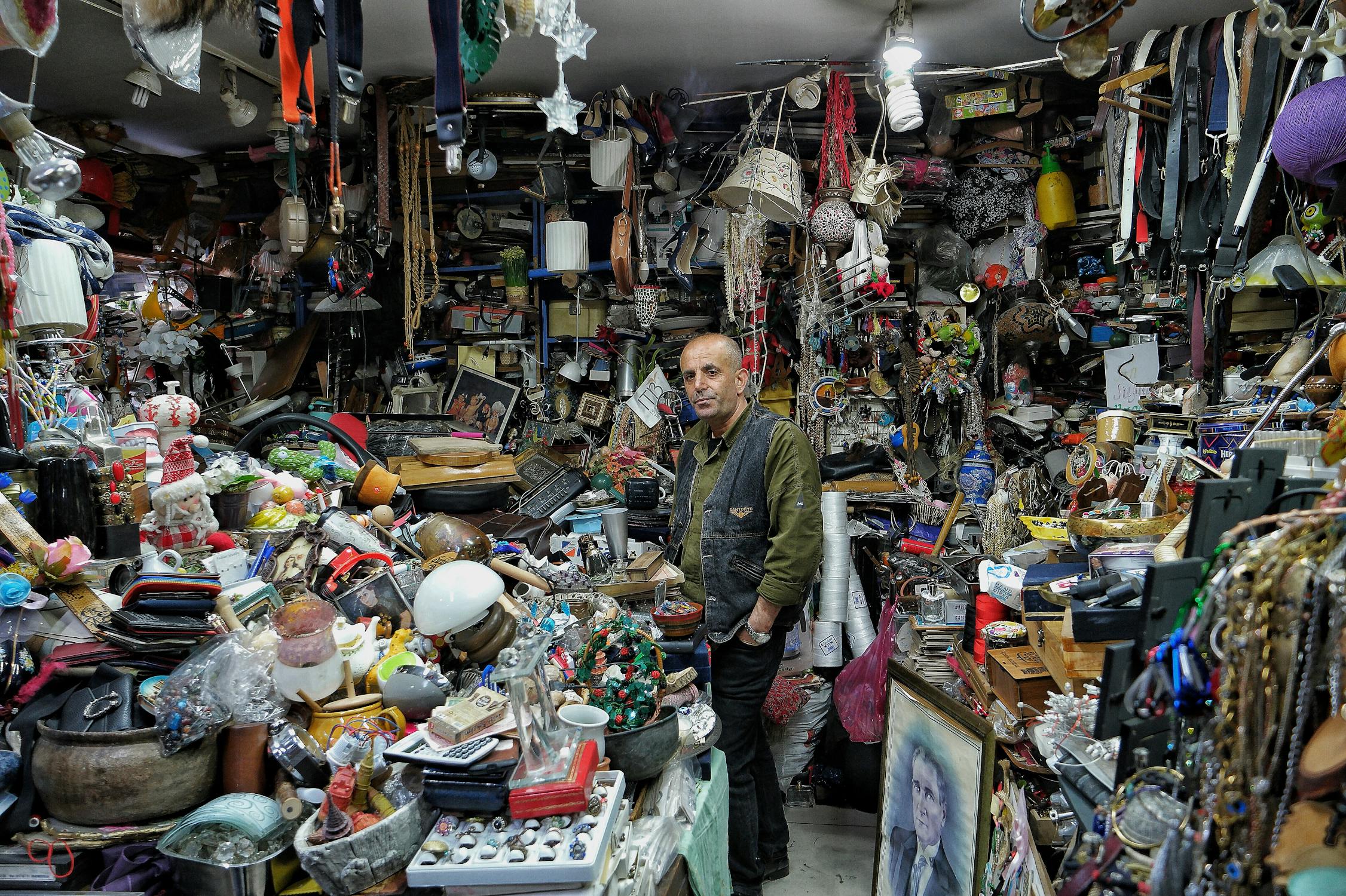 Man Standing in a Cluttered Antiques Shop · Free Stock Photo