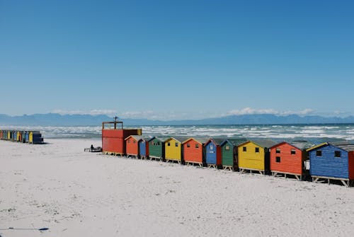 Multi Colored Wooden Cabin on Sandy Beach
