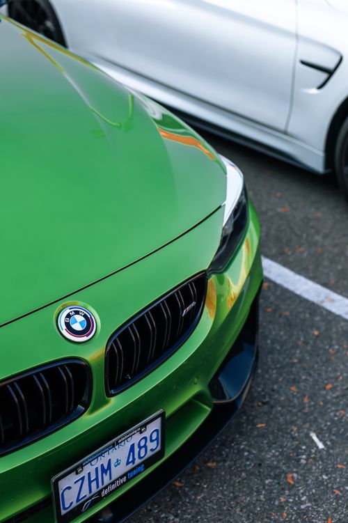 Free A detailed view of a green sports car's front with visible license plate, parked outdoors. Stock Photo