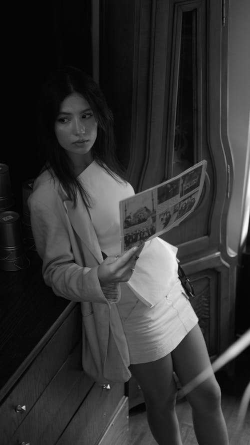 Woman Holding a Newspaper in Black and White 