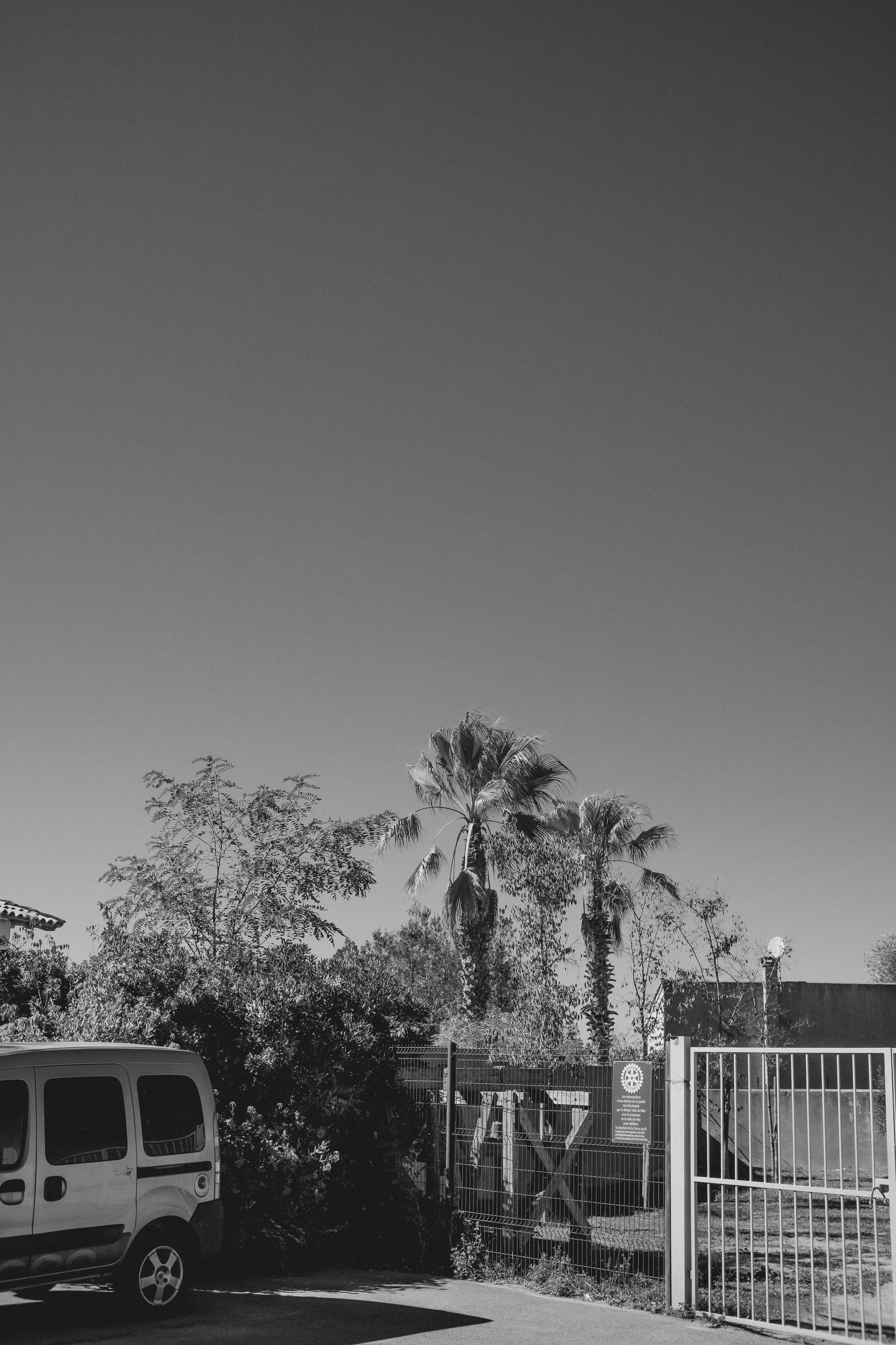 Car Parked in Front of a Fence · Free Stock Photo