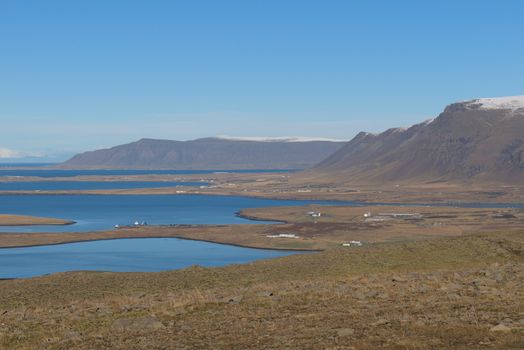 Picturesque coastal landscape of Mosfellsbær, Iceland with mountains and sea.