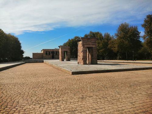 Free The ancient Temple of Debod in Madrid surrounded by trees under a blue sky. Stock Photo
