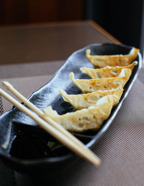 Free From above of delicious traditional Asian gedza made from pastry with meat fried on oil with soy sauce Stock Photo