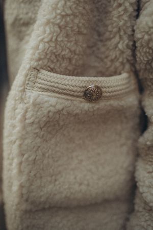 Cream sherpa fleece jacket pocket detail, photo by Aljona Ovtsinnikova on Pexels