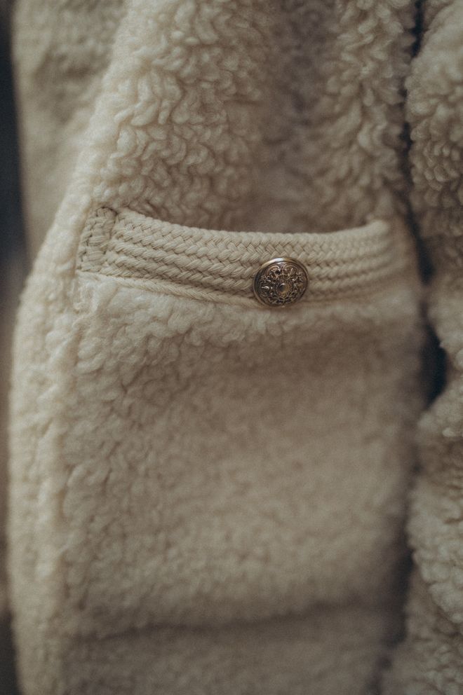 Close view of a cream fleece pocket and button — photo by Aljona Ovtṣinnikova from Pexels