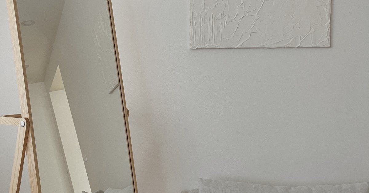 A cozy minimalist living room with a mirror reflecting light, promoting a warm and soothing atmosphere.