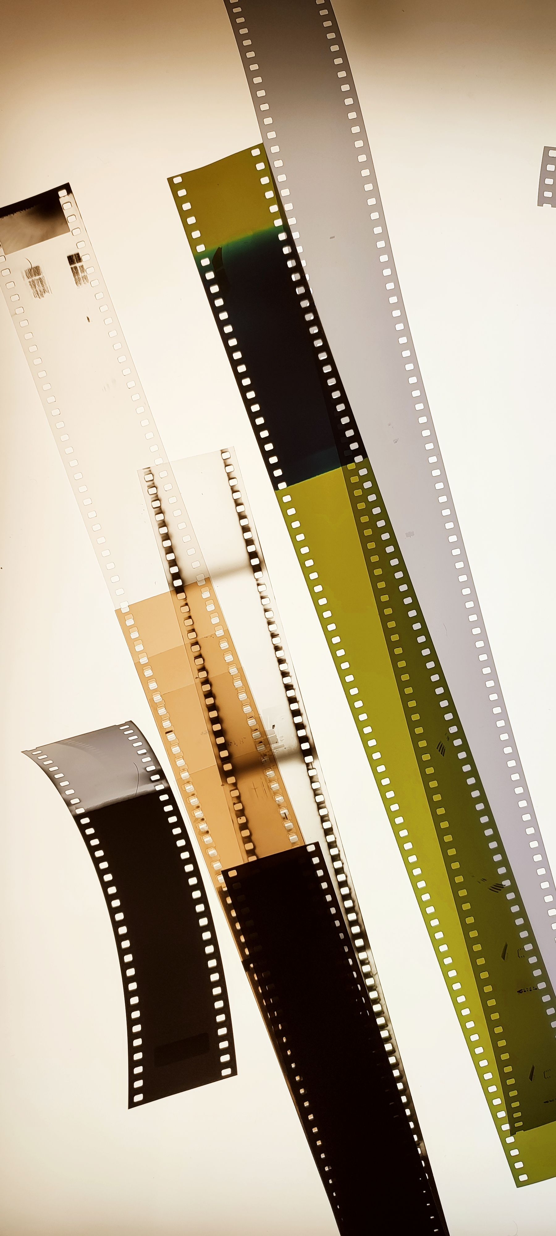 Artistic display of various film negatives in a vertical arrangement.