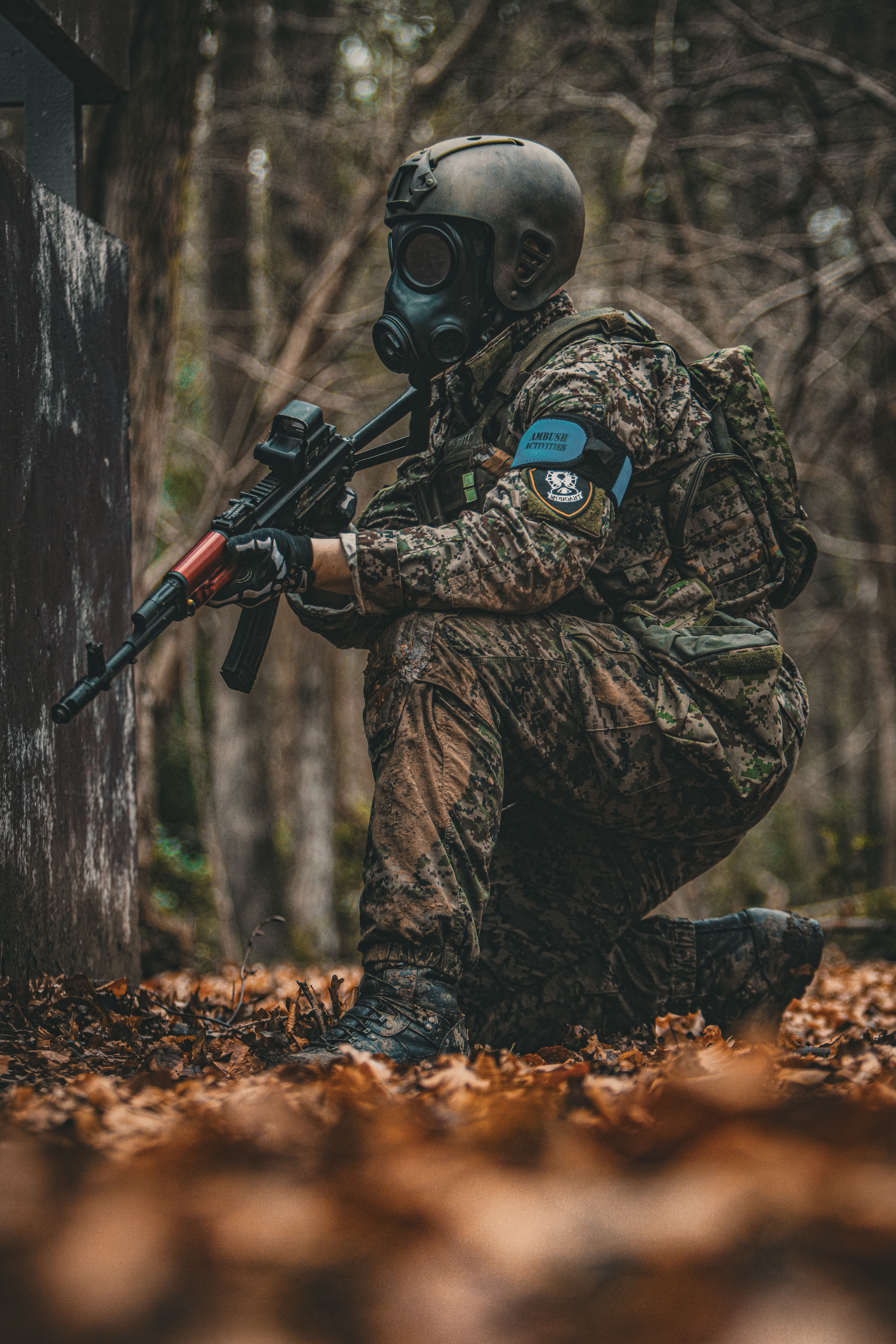 Armed Soldier with a Gas Mask on Lurking in a Forest · Free Stock Photo