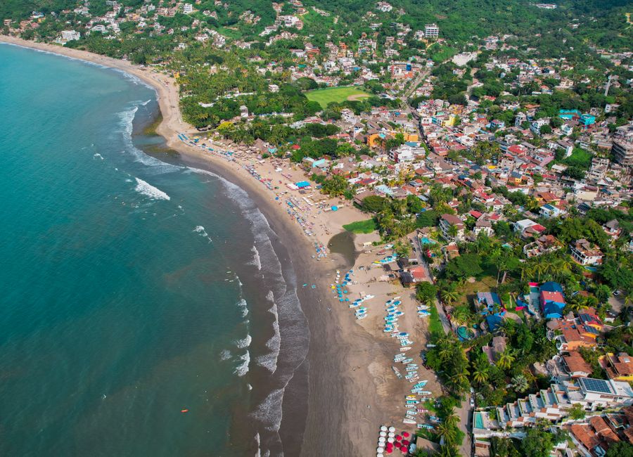 Discover the stunning coastline of Sayulita, Mexico from above with its vibrant town and turquoise waters.