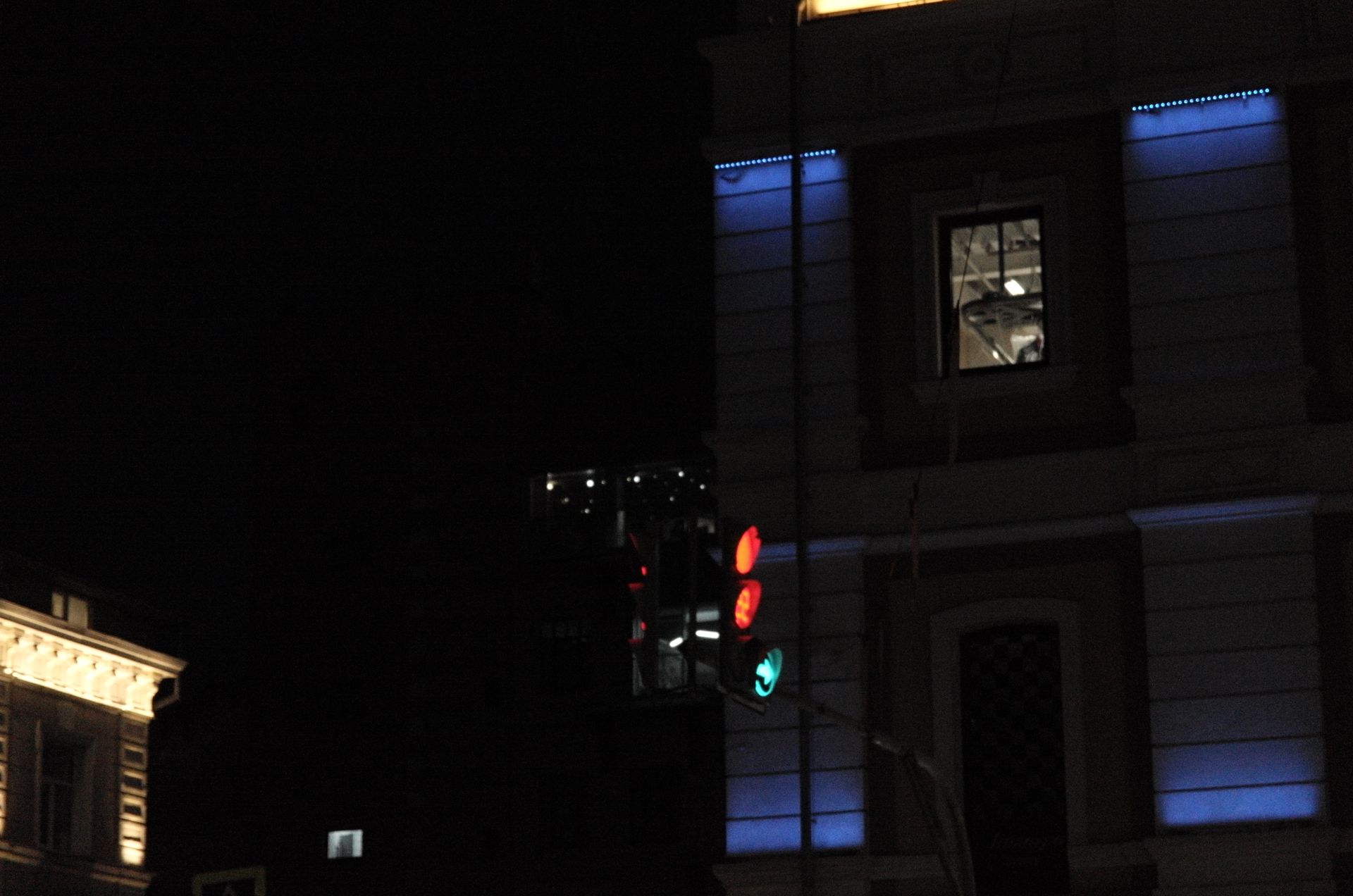 A building exterior illuminated at dusk.