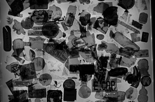 A creative arrangement of various black and white stickers on a wall in abstract form.