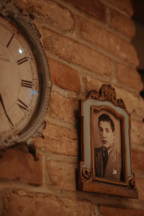 Vintage Clock and Photo on Red Brick Wall