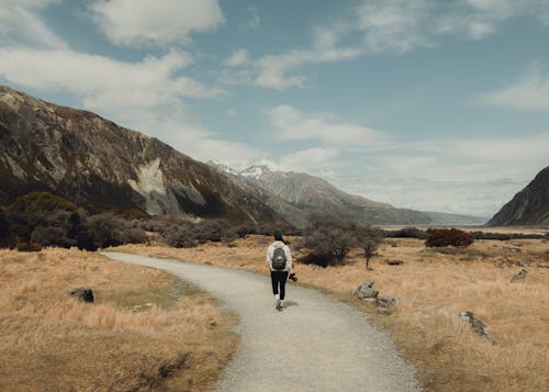 Woman Hiking on Footpath in Valley