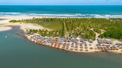 Free Aerial shot of a tropical beach with huts and palms in Conde, Brazil, showcasing leisure and natural beauty. Stock Photo