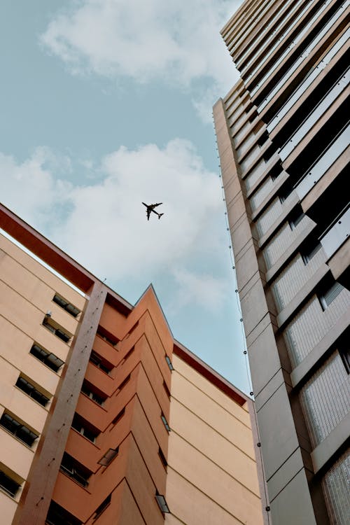 Free Airplane Above A Building Stock Photo