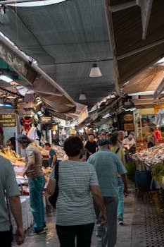 Experience the lively atmosphere of a bustling Turkish bazaar with diverse shoppers and vibrant stalls.