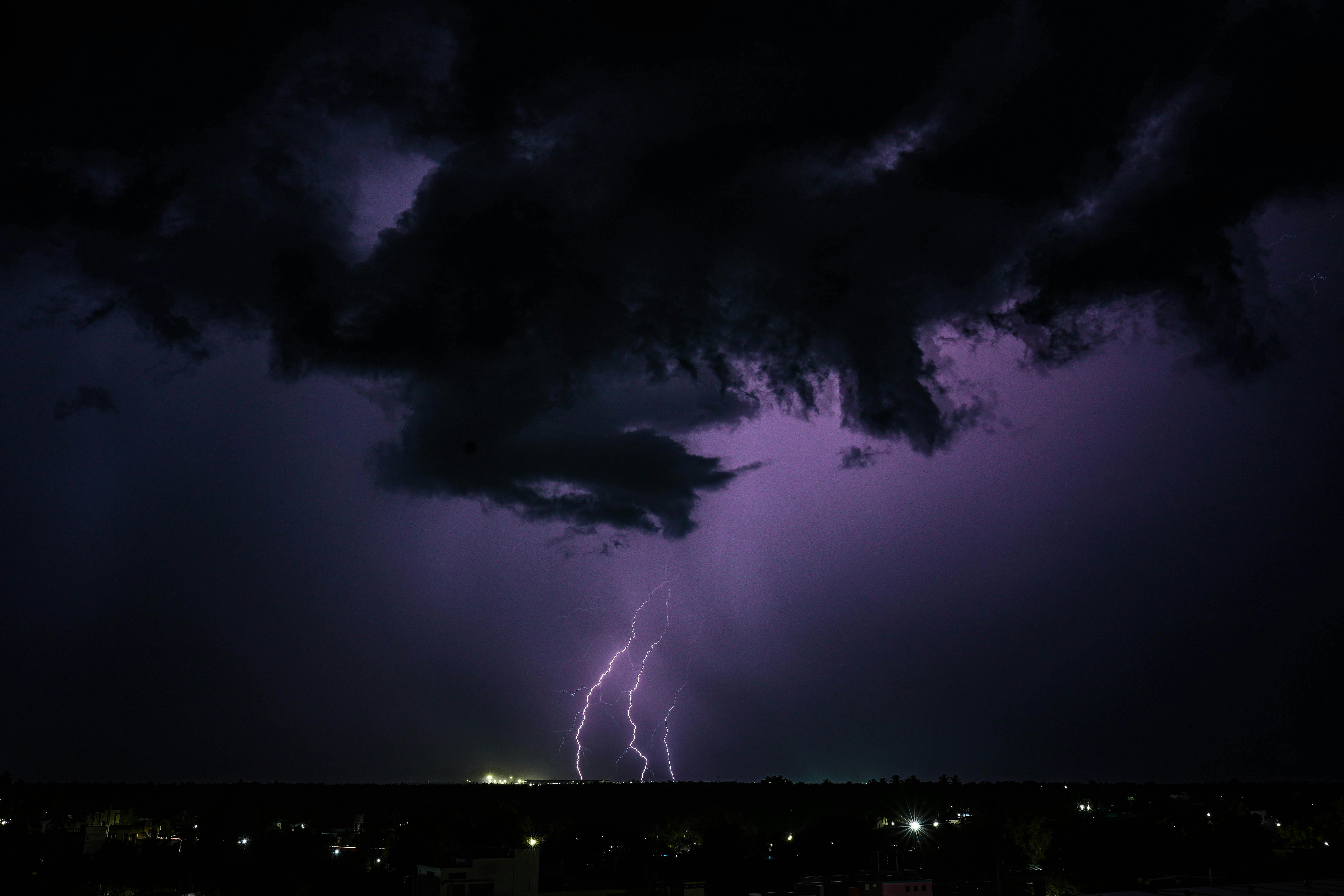 purple night sky with thunderstorm