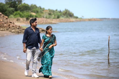 Couple Walking on the Beach Holding Hands