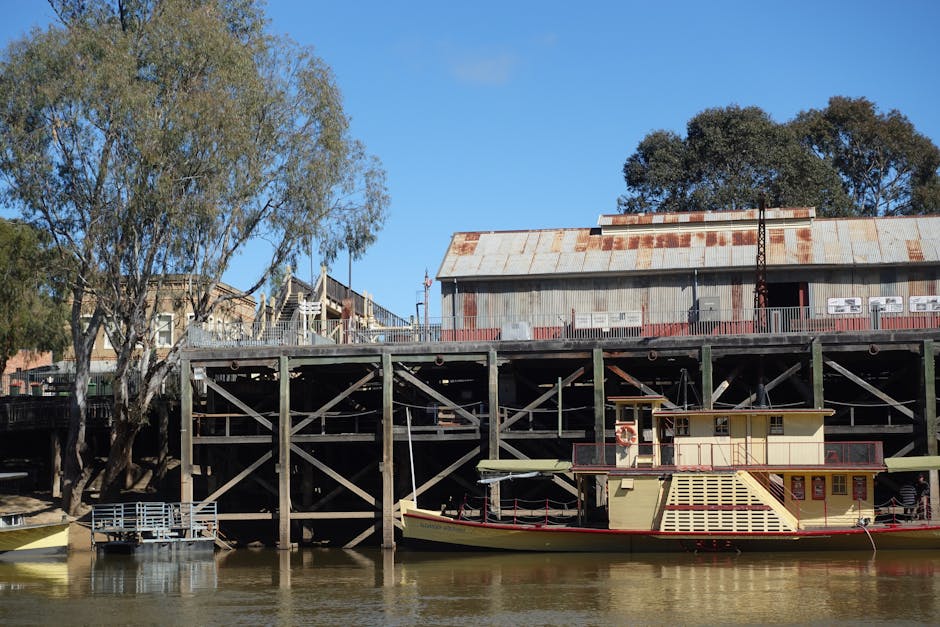 Paddle steamer docked at the scenic Echuca Wharf on a clear day.
