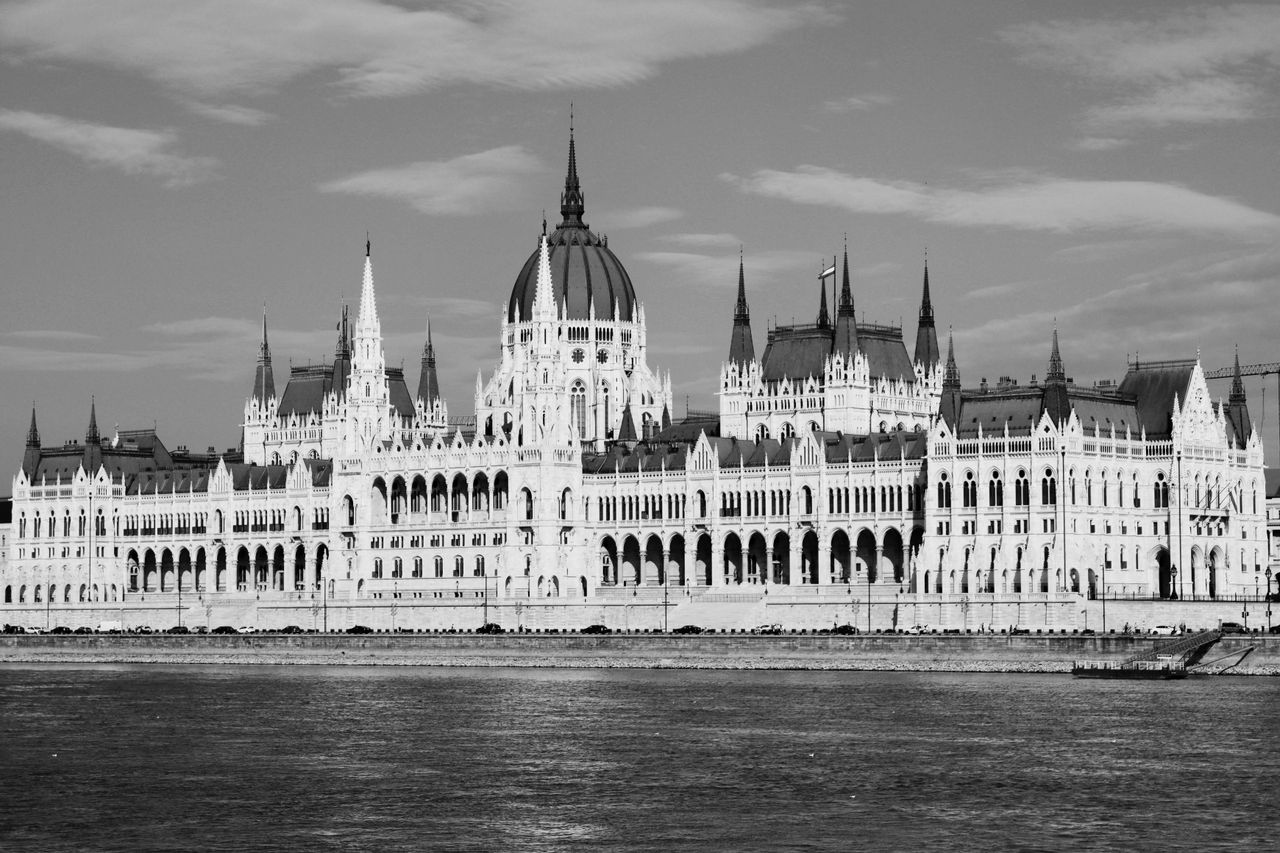 monochrome photo of the hungarian parliament building by the danube ri
