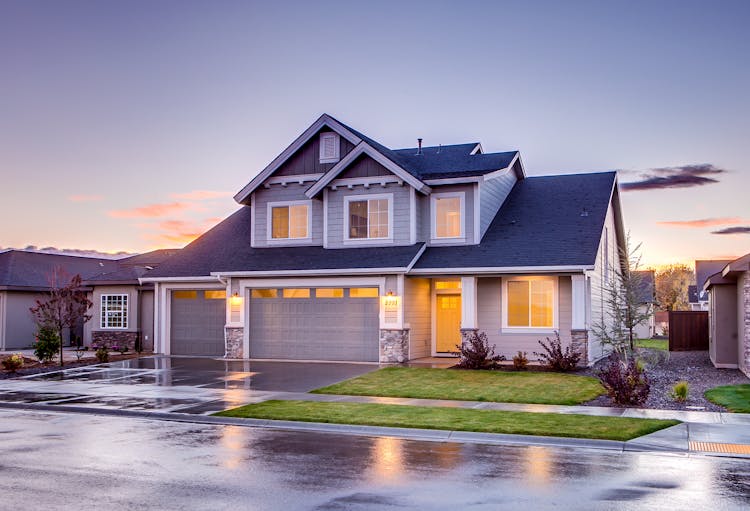 Blue And Gray Concrete House With Attic During Twilight