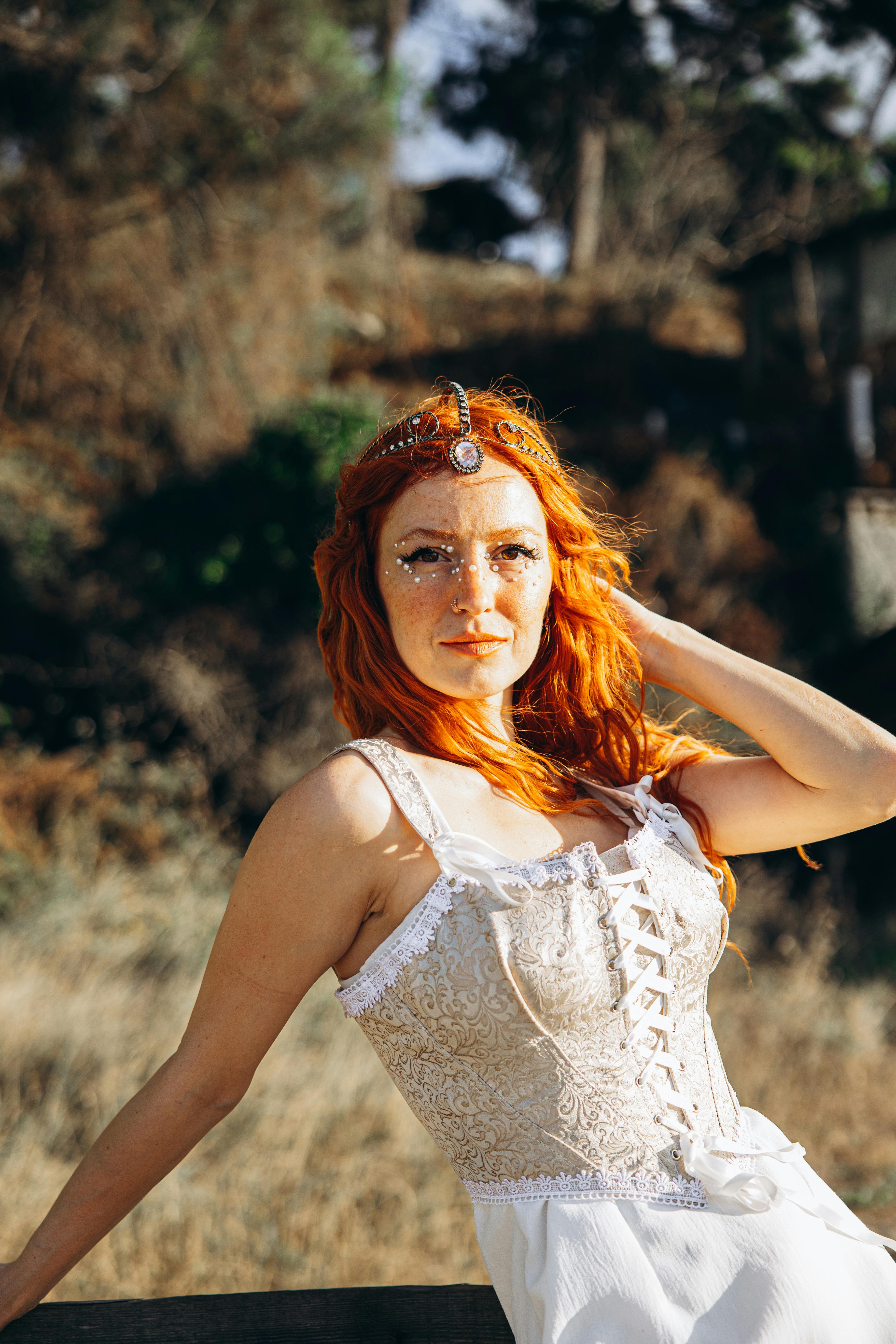 a woman with red hair posing for a photo