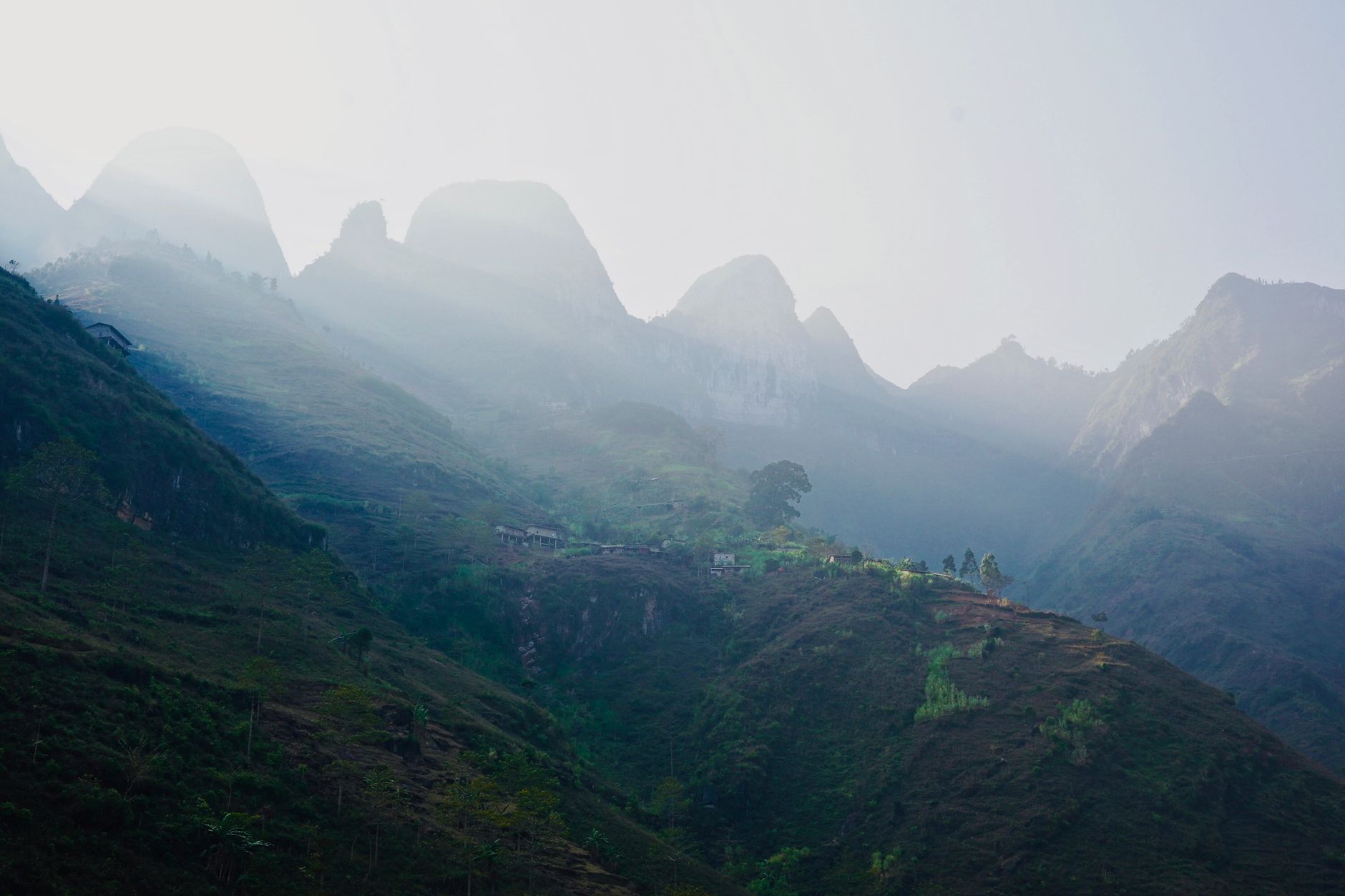 Scenic view of mist-covered mountains at sunrise in Hà Giang, Vietnam.