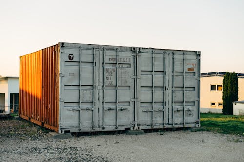 Two shipping containers sitting in front of a building