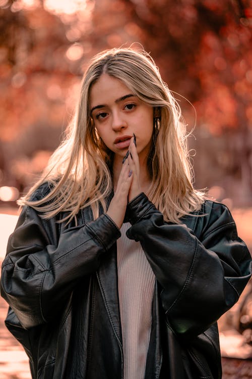 Young Woman in a Leather Jacket in the Autumn Park