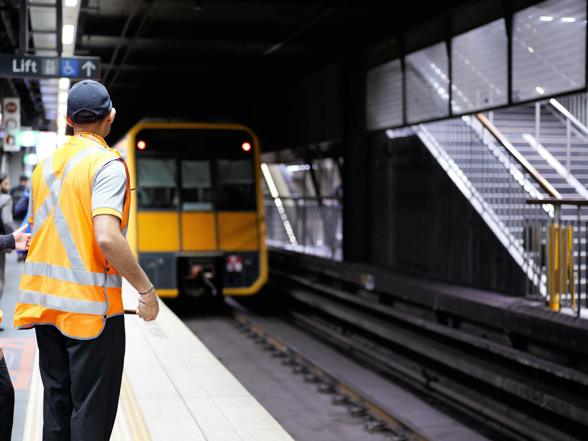 Man of Railway Staff Stands on Platform