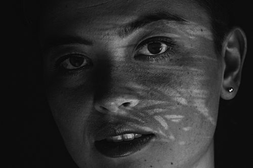 Free Black and white portrait highlighting facial expression and light contrast. Stock Photo