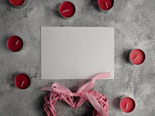 White Paper Beside a Pink Ribbon