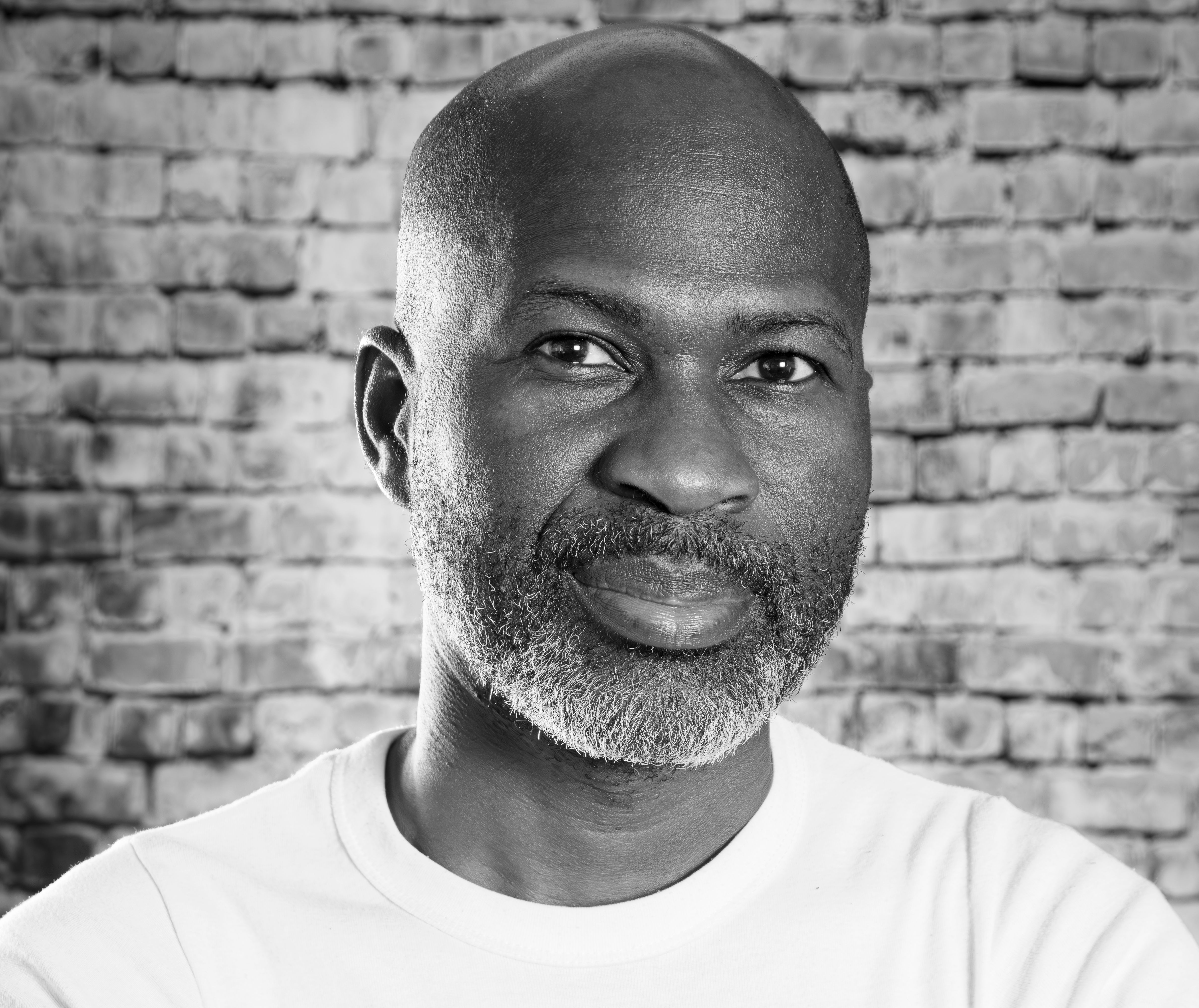 A striking black and white portrait of a mature man with a thoughtful expression.