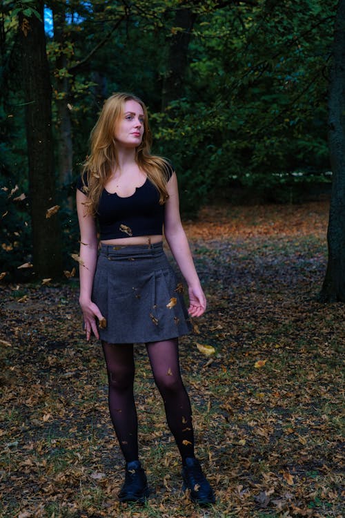 Female Model Wearing a Skirt and a Crop Top Standing in an Autumn Park