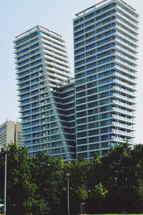 Free Elevated view of V Tower's modern architecture amidst urban Prague skyline. Stock Photo