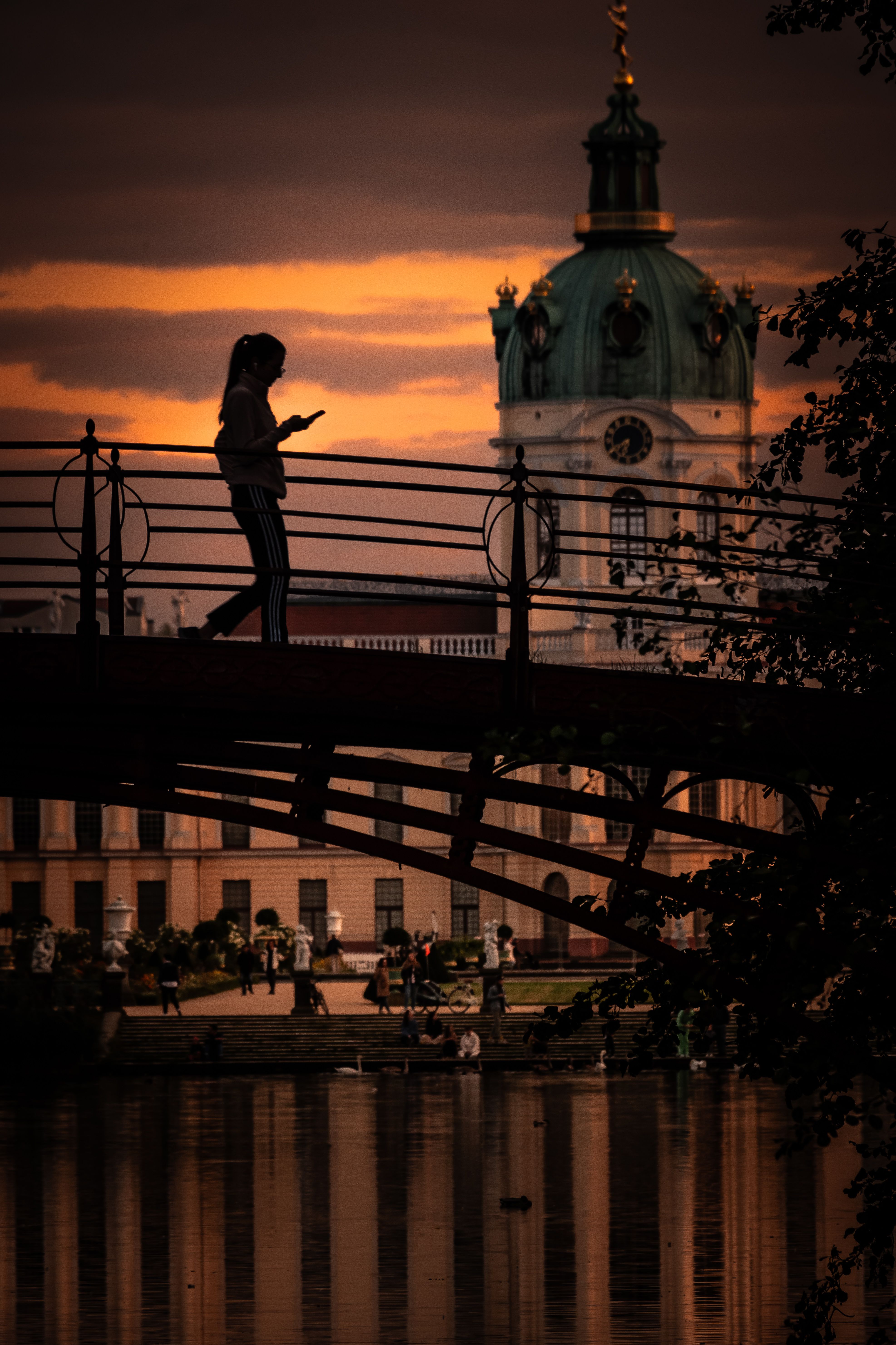 Silhouette of a Woman Walking across a City Bridge at Dusk · Free Stock ...