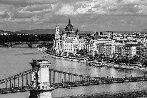 Free Stunning black and white photograph of Budapest's Parliament and the Széchenyi Chain Bridge over the Danube River. Stock Photo