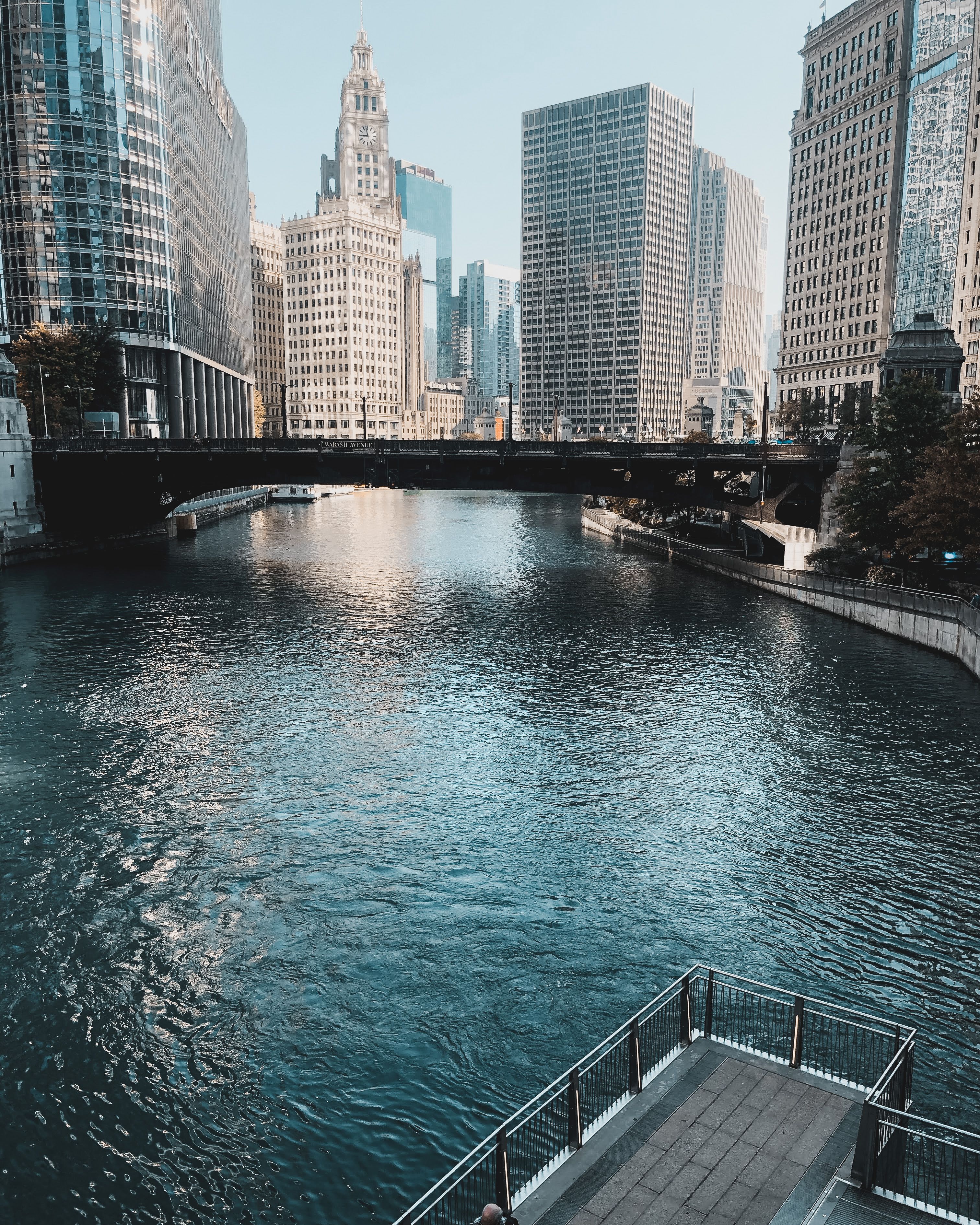 A river with a bridge in front of tall buildings · Free Stock Photo