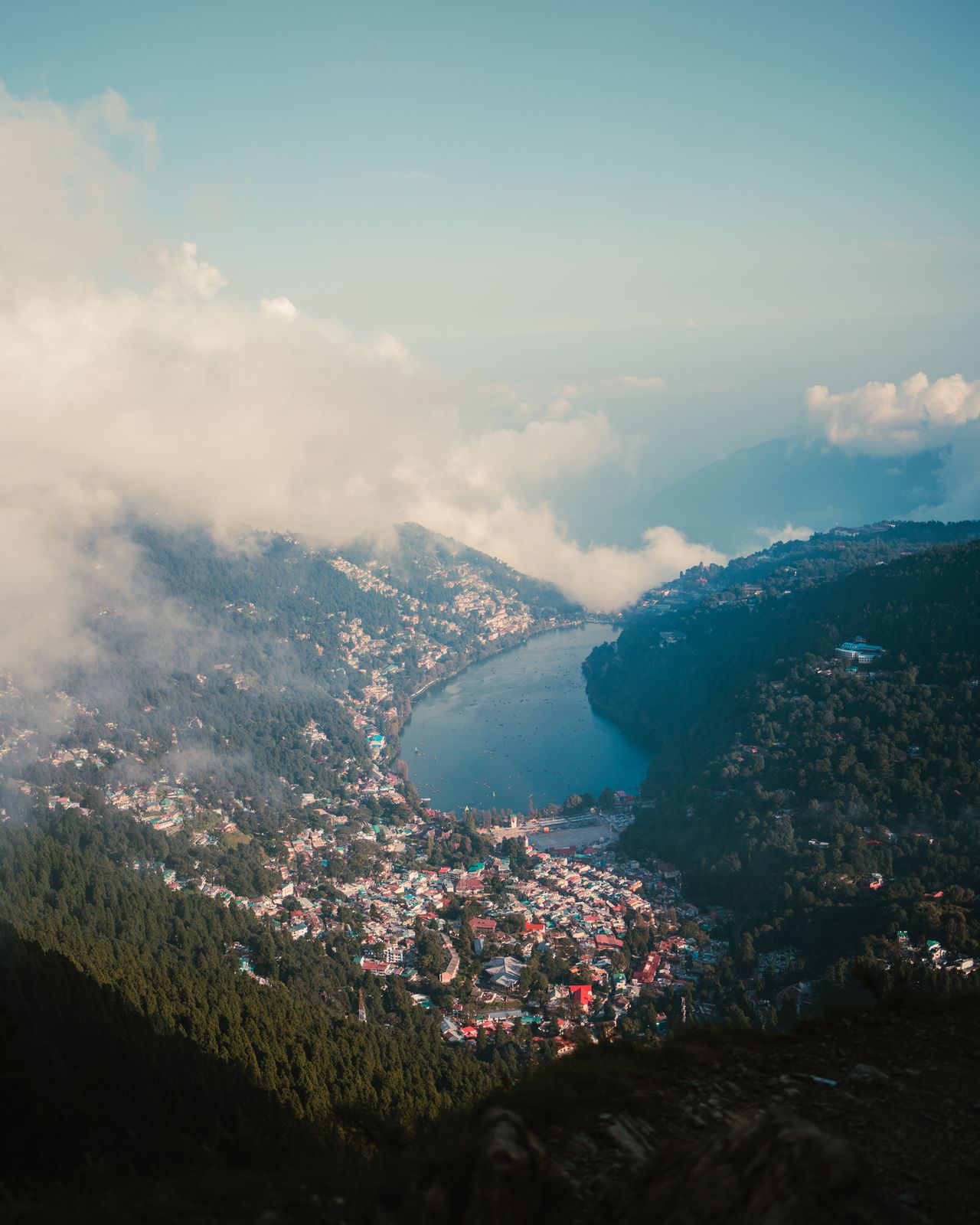 Nainital lake from above, ringed by mountains under a clear sky