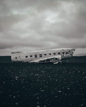 Eerie scene of the Solheimasandur plane wreck under a gloomy, overcast sky.