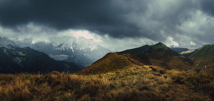 A breathtaking view of the Italian Alps under stormy skies, showcasing rugged peaks and valleys.