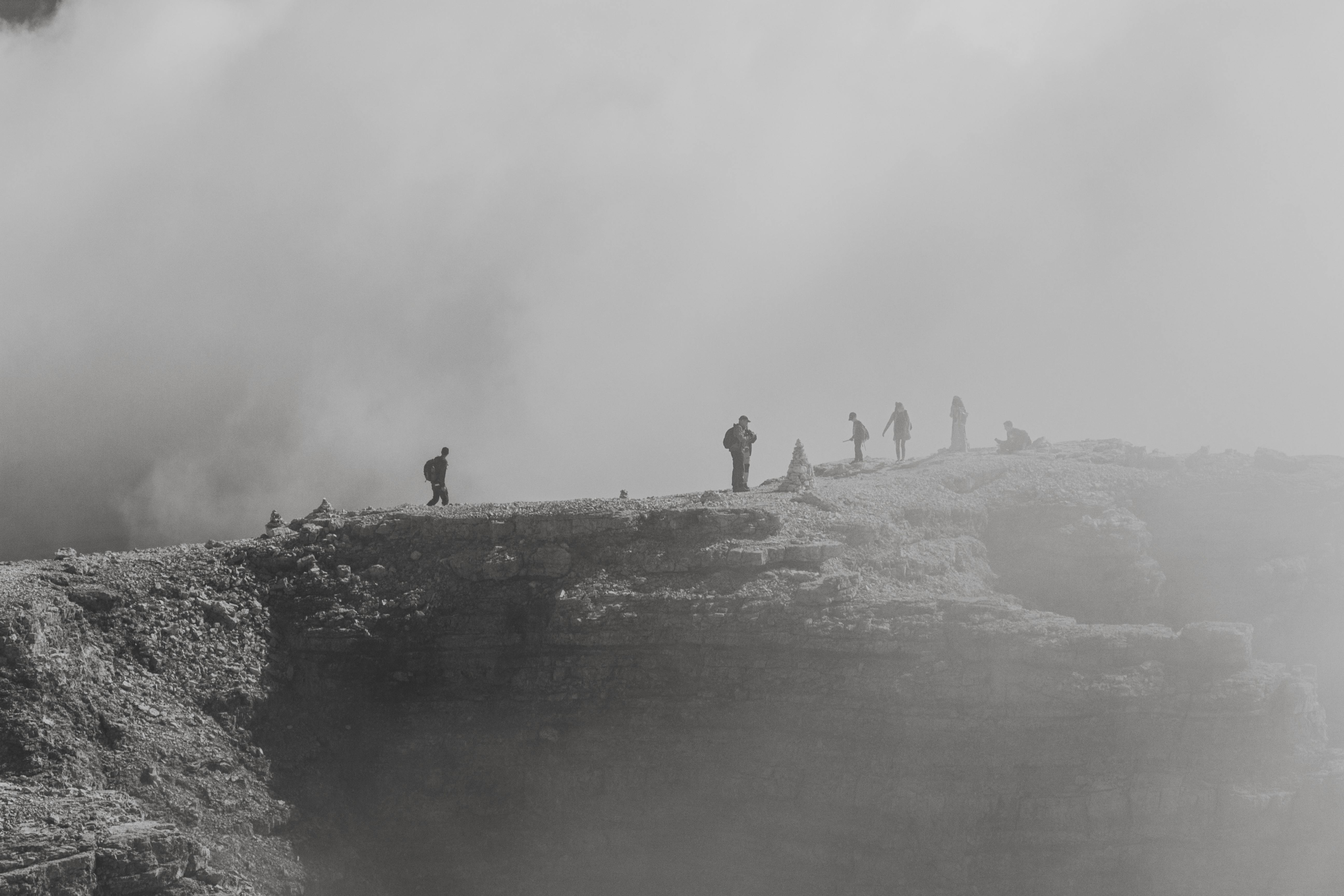 Hikers exploring the misty landscape of Passo Pordoi, Veneto, Italy in winter.