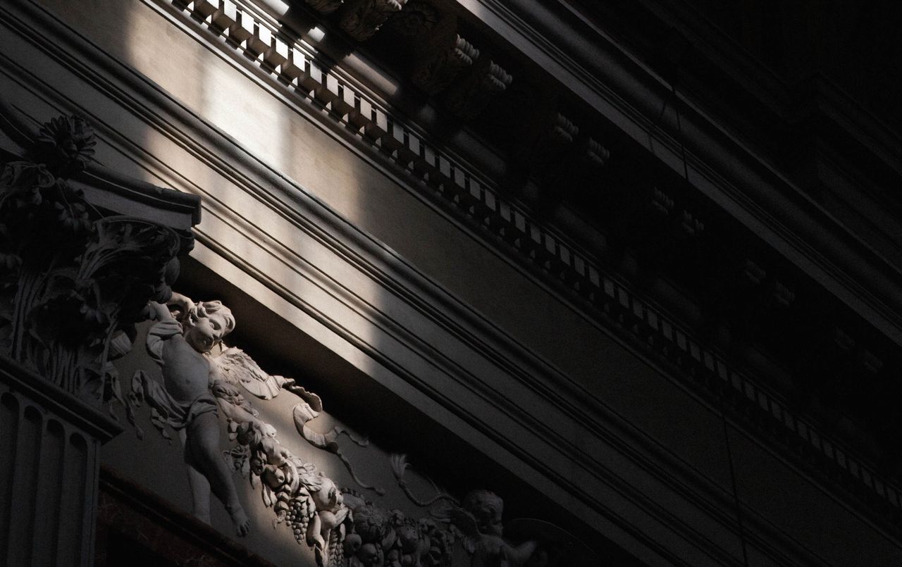 closeup of ornate baroque architecture featuring cherub relief in dram