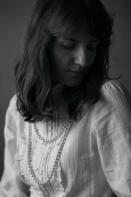 Free Timeless black and white portrait of a woman in elegant attire. Stock Photo