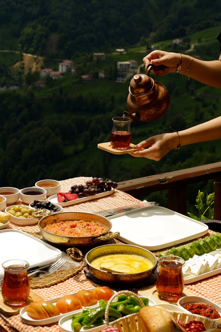 Woman Hands With Tea Over Table With Breakfast