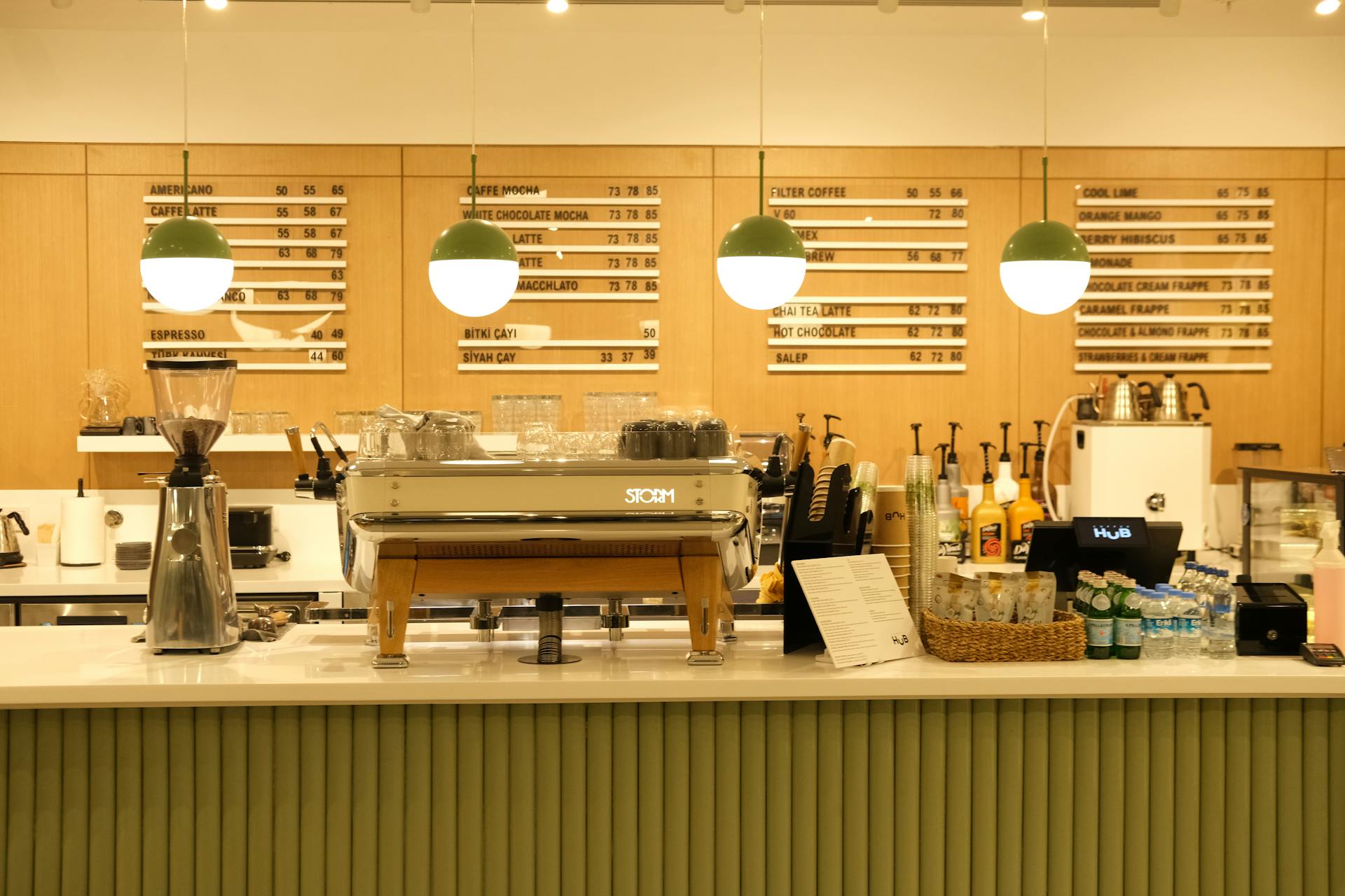 Inviting coffee shop counter showcasing coffee machine, menu board, and cozy ambiance.